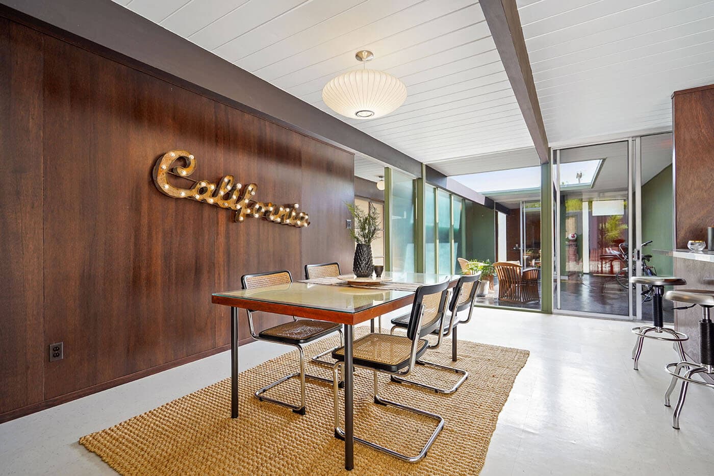 A mid-century dining room with a walnut wall, photographed by a member studio
