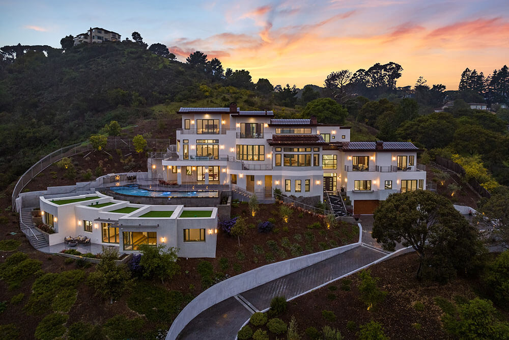 A hillside estate at dusk, photographed by Aerial Canvas